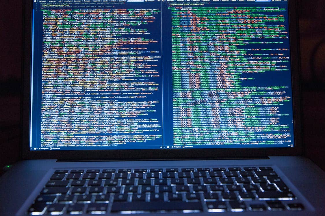 working on programming codes in a laptop
